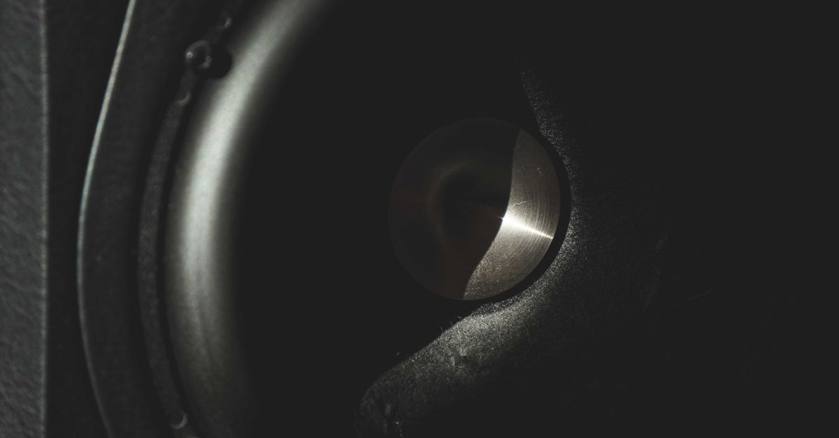 Closeup of black round sound acoustic speaker for playing loud music and sounds